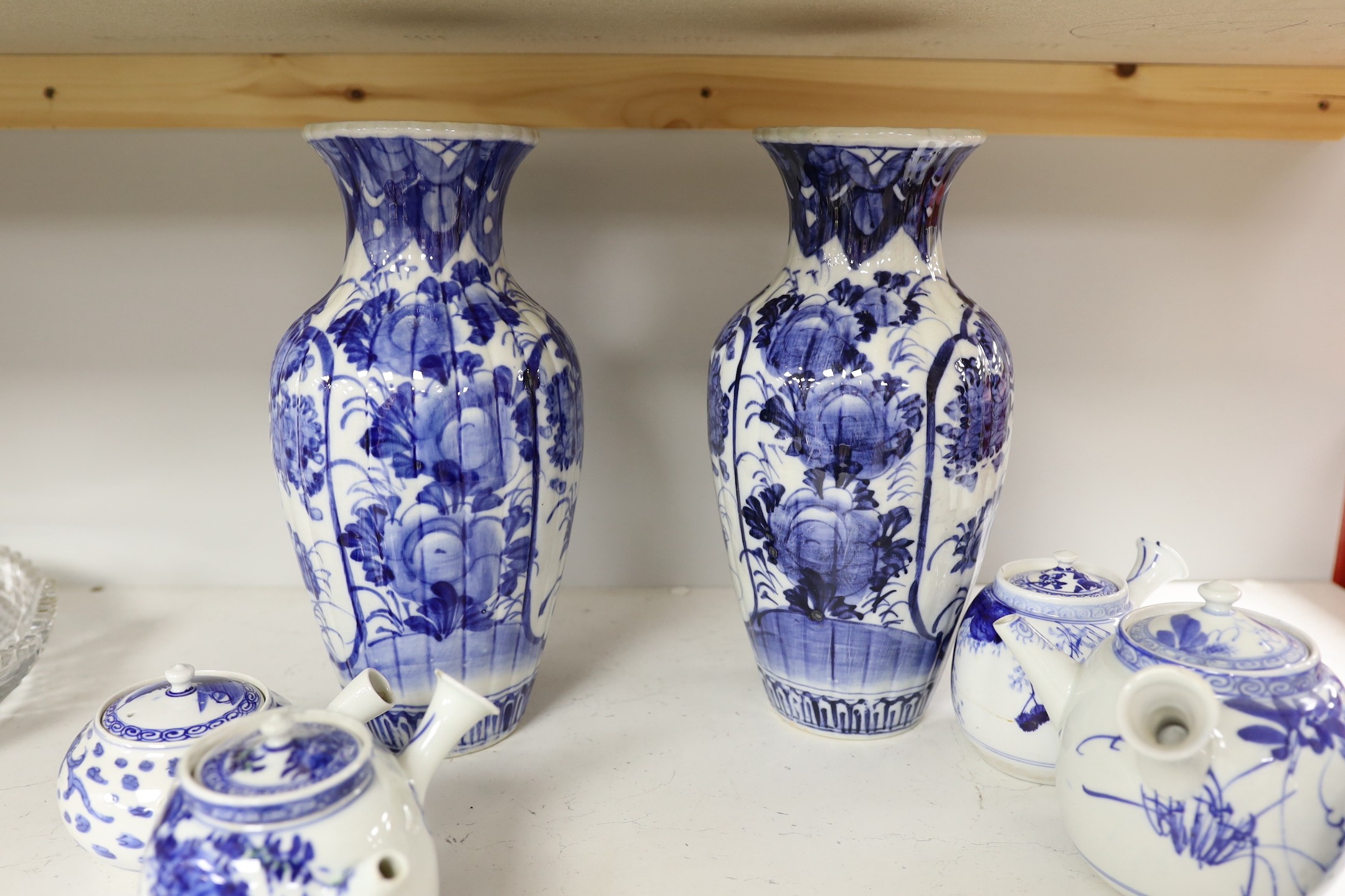 A pair of Japanese blue and white vases and various Japanese blue and white porcelain teapots and covers, tallest 30cm